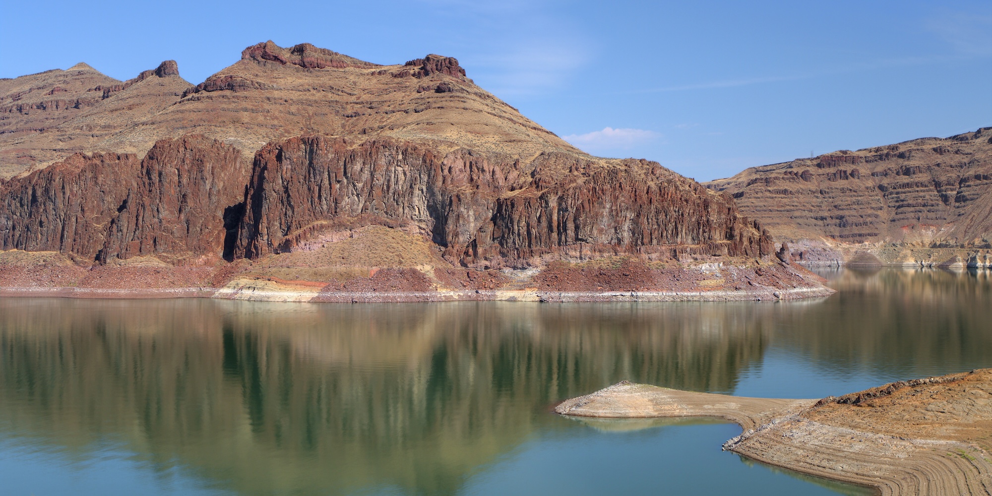 Rock formations beside a desert lake