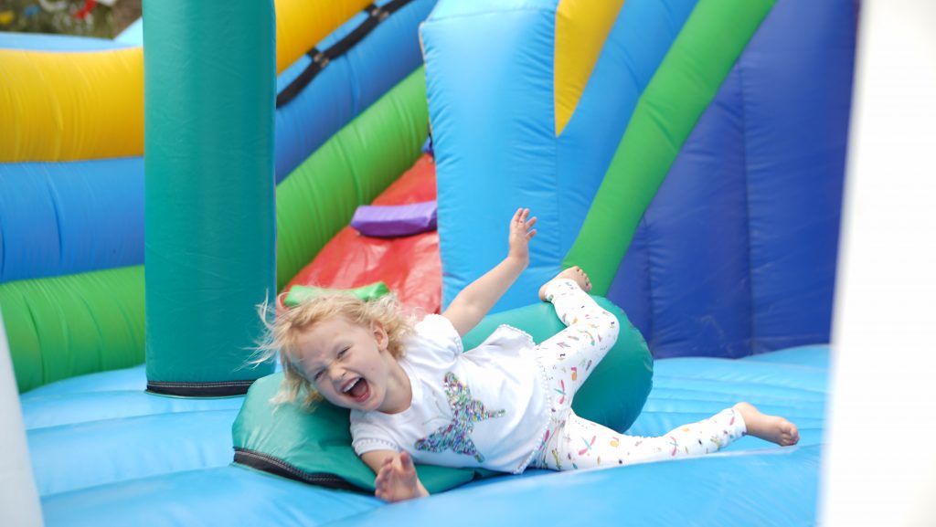 A child playing on a bouncy castle at the DGS Family Festival