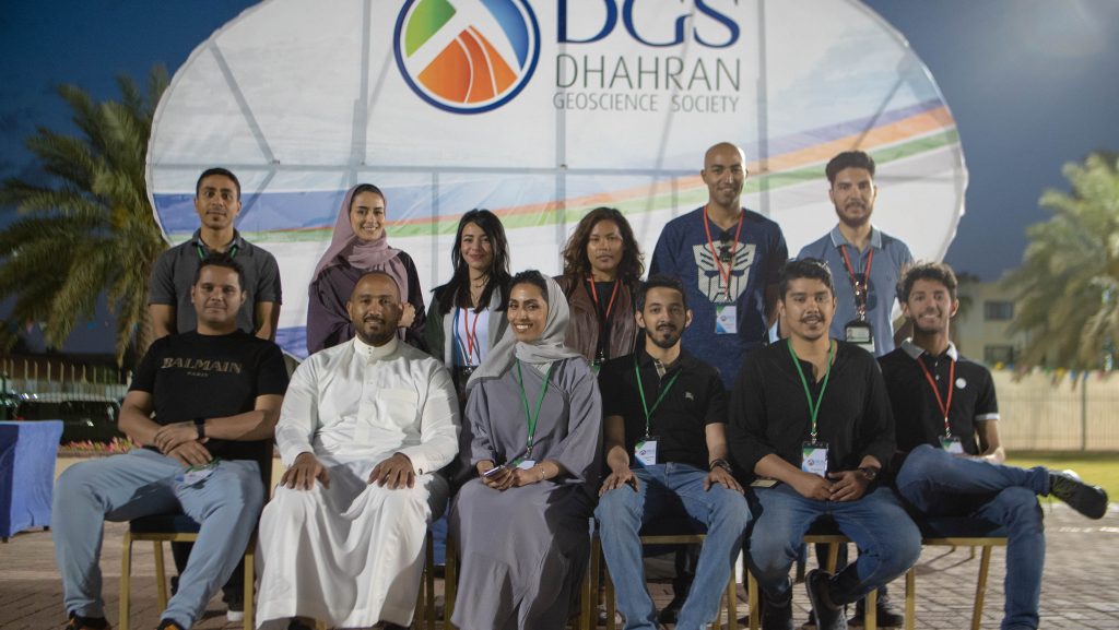 Group photo of participants in front of a DGS backdrop