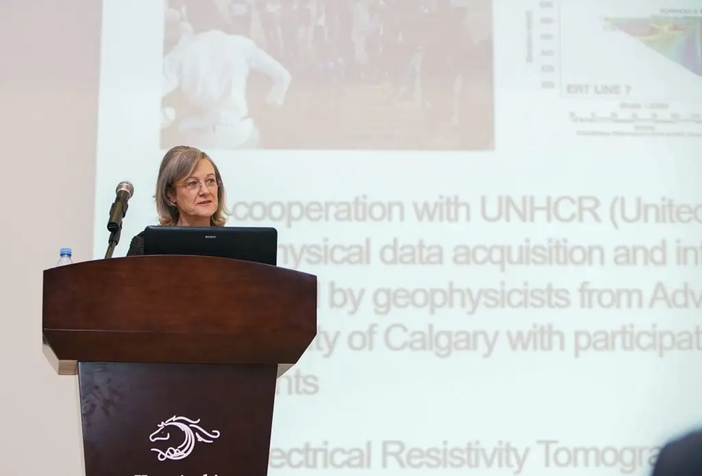 Speaker presenting slides from the podium at the DGS dinner meeting with the SEG President