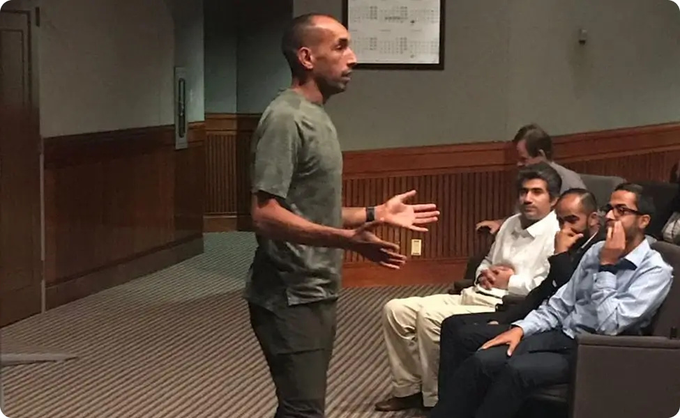 A mentor speaking to young professionals at a DGS session