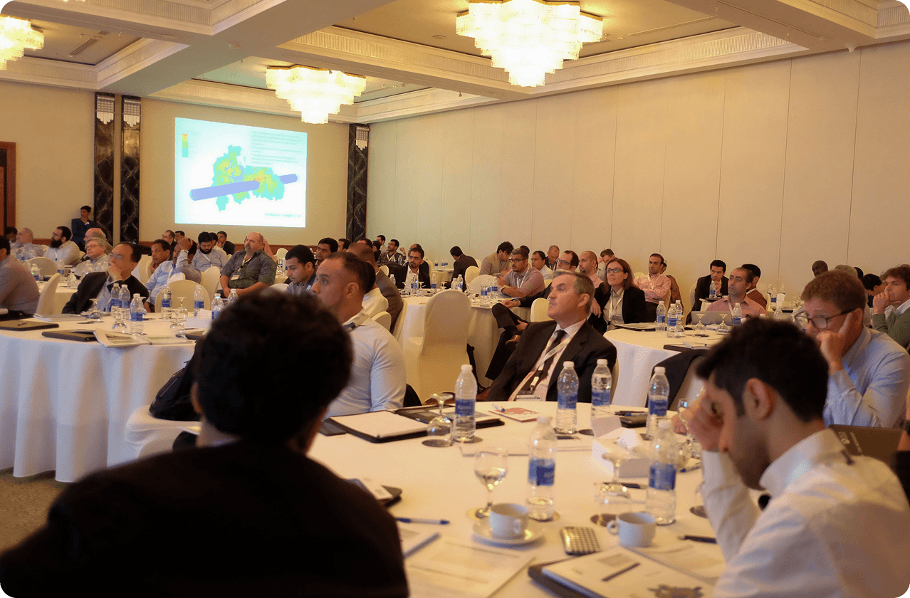 Attendees seated at tables during a DGS workshop