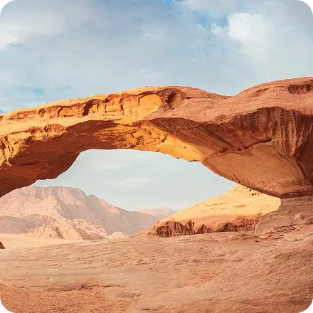 Natural rock arch in the desert at dusk