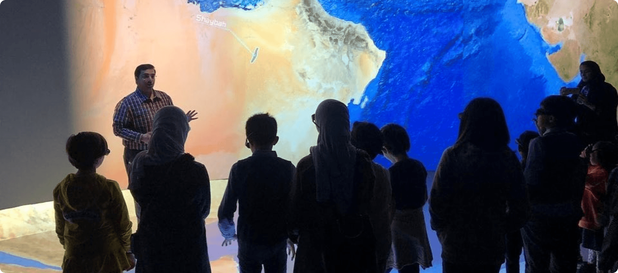 Visitors viewing a large geoscience exhibit display